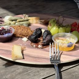 Premium cheeses, cured meats paired w fresh, peak-season fruits and an assortment of artisanal crackers Premium cheeses, cured meats paired w fresh, peak-season fruits and an assortment of artisanal crackers