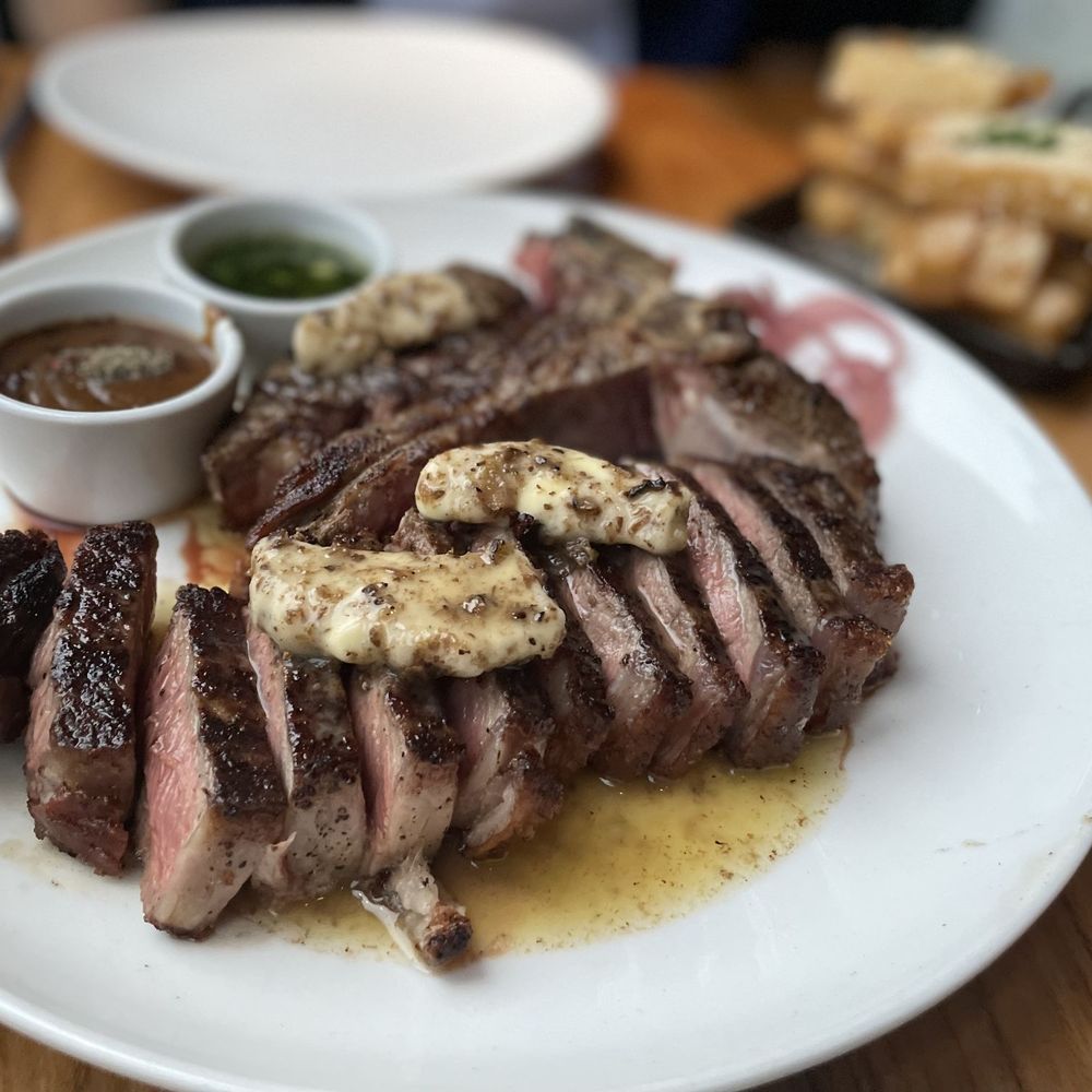 STK Steakhouse Toronto - Porterhouse with Truffle Butter Glazed, Au Poivre and Chimichurri sauce - Steakhouses Near Me - Toronto, Ontario STK Steakhouse Toronto - Porterhouse with Truffle Butter Glazed, Au Poivre and Chimichurri sauce - Steakhouses Near Me - Toronto, Ontario