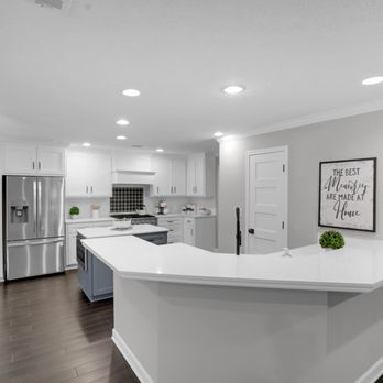 NHC Remodeling - a kitchen with a center island - General Contractors Near Me