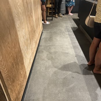 Chipotle Mexican Grill - At least 10 People waiting for app orders. 30 mins or more waiting. - Several individuals stand in line at a food service counter, with some looking at their phones, in a casual dining setting. - Fast Food Near Me - Reading, Pennsylvania