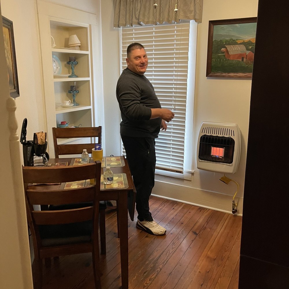 Hidden Springs Bed & Breakfast - Husband warming himself in the little dining room - Hotels Near Me - Eureka Springs, Arkansas Hidden Springs Bed & Breakfast - Husband warming himself in the little dining room - Hotels Near Me - Eureka Springs, Arkansas