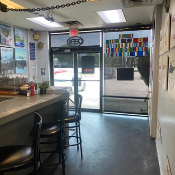 The Hangar Bay Cafe & Gallery - Small bar area looking toward outside - New American Near Me - Atlantic Beach, Florida The Hangar Bay Cafe & Gallery - Small bar area looking toward outside - New American Near Me - Atlantic Beach, Florida