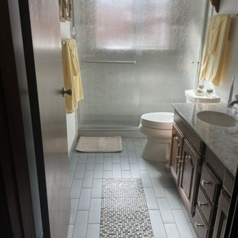 EZ Baths - View of shower doors in "rain", toilet in biscuit by Kohler, partial view of vanity and tile floor (existing) - General Contractors Near Me - Hayward, California