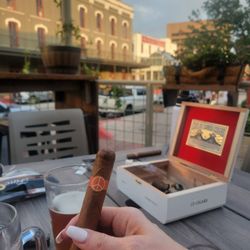 Havana Harbor Cigars - Customer enjoying a cigar on our garden patio