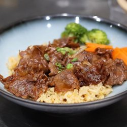 Taroko Asian Bar And Grill - Tender glazed beef over savory fried rice with fresh broccoli and carrots. A flavorful Asian-inspired meal at Taroko Asian Bar & Grill.