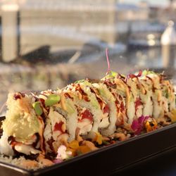 Buddha's Favorite - OMF Roll Tuna, yellowtail, shrimp, kani kama, masago topped with avocado, spicy mayo, eel sauce and tempura flakes