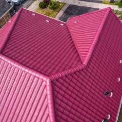 Professional Roofers - Bright Red Metal Roof installation done for a client in Toronto