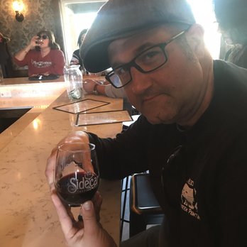 Sidecar Tasting Room - Husband tasting the wine - Wine Bars Near Me - Dripping Springs, Texas Sidecar Tasting Room - Husband tasting the wine - Wine Bars Near Me - Dripping Springs, Texas
