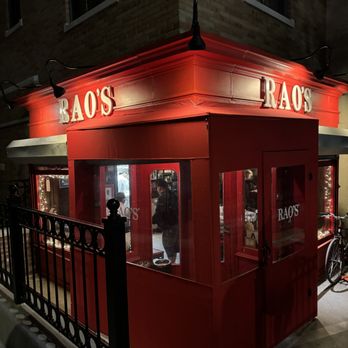 Rao's - a red building with a bicycle parked in front of it - Italian Near Me - New York, New York