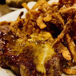 Del Rio Ribeye Rubbed with bold Southwest spices, topped with ancho chipotle butter and Onion Tanglers