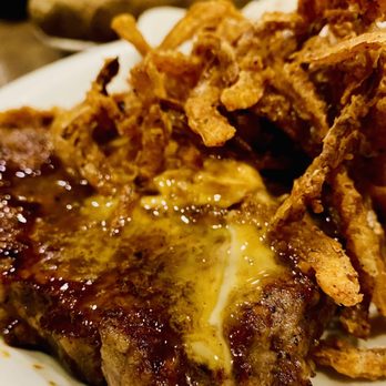 Colton's Steakhouse & Grill - Del Rio Ribeye Rubbed with bold Southwest spices, topped with ancho chipotle butter and Onion Tanglers - Steakhouses Near Me - Cabot, Arkansas