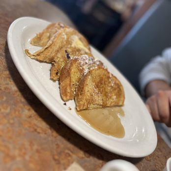Huckleberry’s - a plate of pancakes with syrup - American Near Me - Clovis, California Huckleberry’s - a plate of pancakes with syrup - American Near Me - Clovis, California