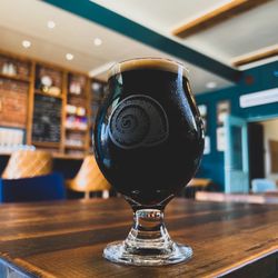 Saint Andrews Brewing - A glass of stout in inside the taproom corner.