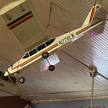 Airport Hanger Bar - a model of an airplane suspended from the ceiling - Bars Near Me - Sanford, Florida