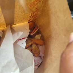 a person holding a bag of food a person holding a bag of food