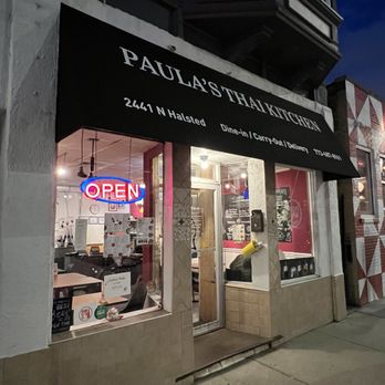 Paula's Thai Kitchen - Outside - Exterior view of Paula's Thai Kitchen restaurant with a black awning, illuminated 'OPEN' sign, and visible interior seating. - Thai Near Me - Chicago, Illinois