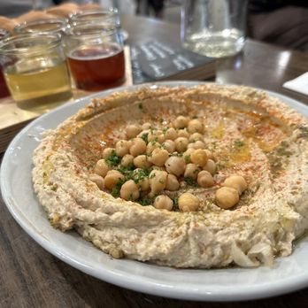 Café Alma - Hummus (served with warm house-made challah bread) with a kombucha flight - Breakfast & Brunch Near Me - Cincinnati, Ohio Café Alma - Hummus (served with warm house-made challah bread) with a kombucha flight - Breakfast & Brunch Near Me - Cincinnati, Ohio