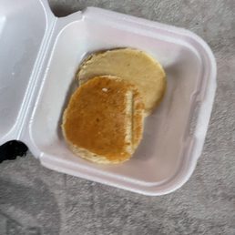 a half eaten sandwich in a styrofoam container
