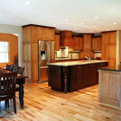 Total Concept & Design - Dark wood island provides interest to lighter cabinets and floor