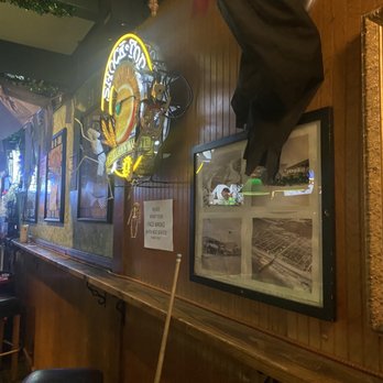 Clancy's - the interior of a bar with a large clock on the wall - Dive Bars Near Me - Seal Beach, California
