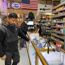 Red Dot Arms - Customer looking at firearms to purchase in our show room.