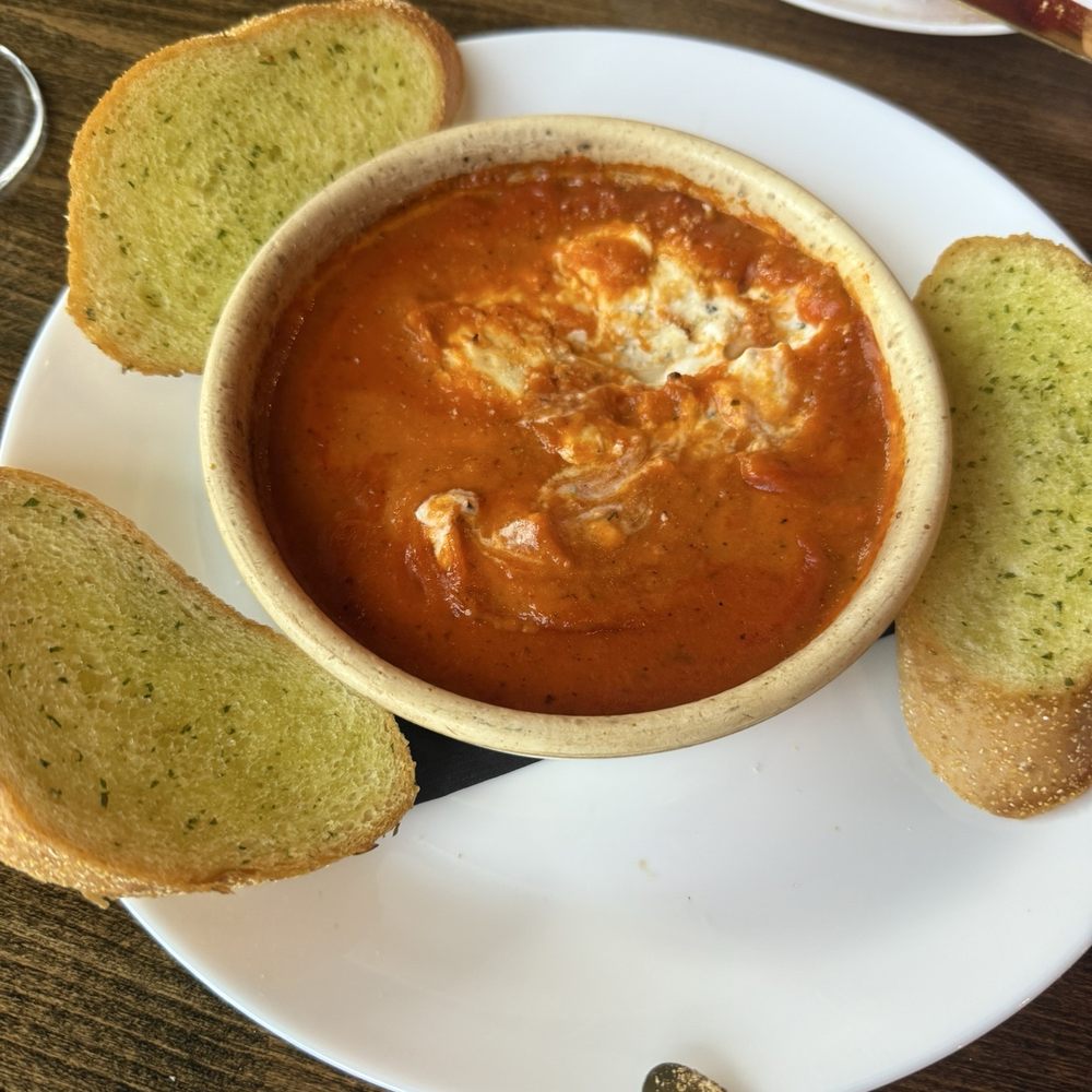Goat cheese and tomato dip with garlic bread