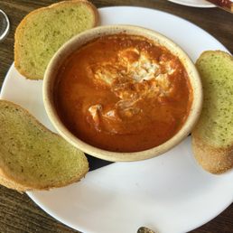 Goat cheese and tomato dip with garlic bread