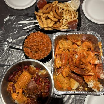 King Cajun Crawfish - Calamari Platter on top, jambalaya to the left, king feast to the right, and the crawfish boil on the bottom left. - Cajun/Creole Near Me - Orlando, Florida King Cajun Crawfish - Calamari Platter on top, jambalaya to the left, king feast to the right, and the crawfish boil on the bottom left. - Cajun/Creole Near Me - Orlando, Florida