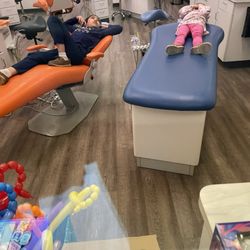 Pediatric Dentistry of Colleyville - The main area.  Notice how my 4-year old just lays down and lets them do their thing??  They also have tv's above and headphones