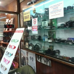Foto Ottica Serraglini - Not sure how Francesco manages to fit such a vast amount of camera lenses and glasses in this small store :) - by danella