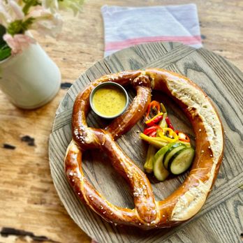 The Ozark Mill - The Farmers Salted Pretzel features a jumbo pretzel, farm fresh pickles, beer mustard - Venues & Event Spaces Near Me - Ozark, Missouri