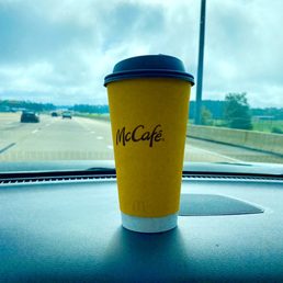 a cup of coffee on the dashboard of a car a cup of coffee on the dashboard of a car