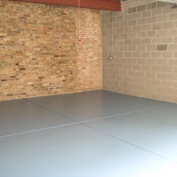Broadleaf - a room with a concrete floor and a brick wall - Flooring Near Me - Westchester, Illinois