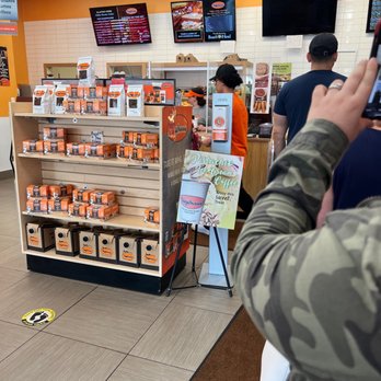 Bagelman - a man taking a picture of a store - Delis Near Me - Brookfield, Connecticut