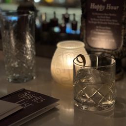 a glass of alcohol and a candle a glass of alcohol and a candle