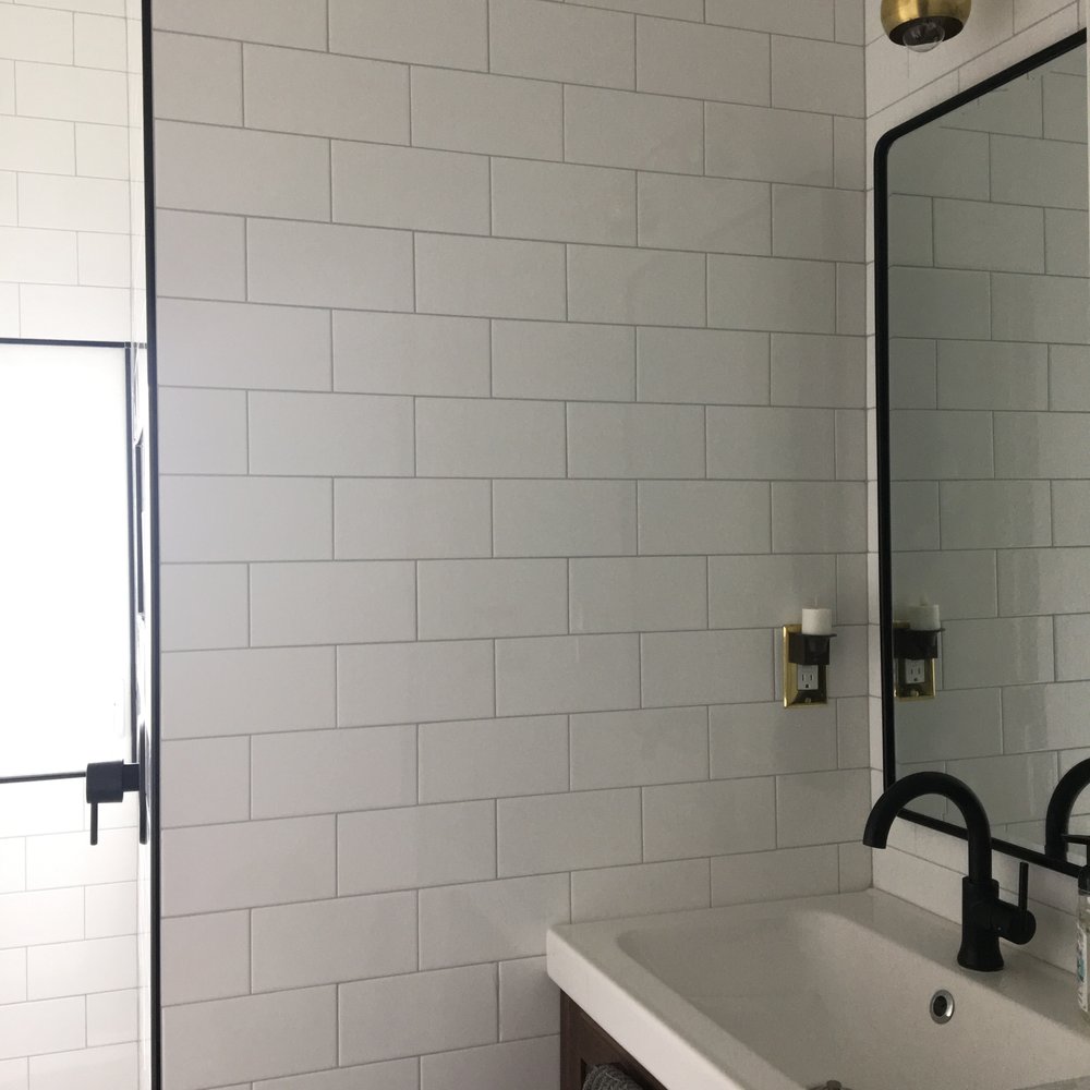 Albert Tile & Fine Stone - a bathroom with a sink and mirror - Flooring Near Me