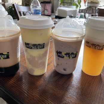 Möge Tee Duluth - (Left to right) brown sugar milk tea, creme brûlée milk tea, taro milk tea, and cheese foam peach oolong tea. - Bubble Tea Near Me - Duluth, Georgia Möge Tee Duluth - (Left to right) brown sugar milk tea, creme brûlée milk tea, taro milk tea, and cheese foam peach oolong tea. - Bubble Tea Near Me - Duluth, Georgia