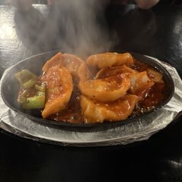A5. Chicken Momo Sizzling (6 Pc) A5. Chicken Momo Sizzling (6 Pc)