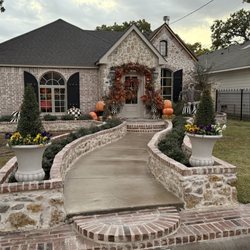 Pertex Masonry Solutions - Custom stone and brickwork entryway with flowerbeds and curved steps -- built to impress and last.