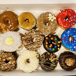 a variety of doughnuts in a box a variety of doughnuts in a box