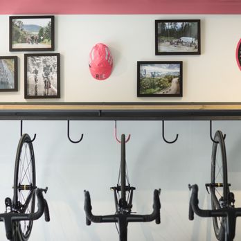 Rapha - Boulder - a wall of bikes hanging on hooks - Sports Wear Near Me - Boulder, Colorado