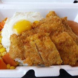 fried pork chop and egg on rice w/ tomato sauce and veggies