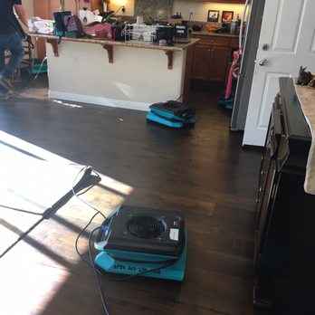 ServiceMaster - Laying out air movers and dehumidifiers - Damage Restoration Near Me