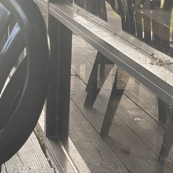 Harps American Pub & Grill - Dirty railing next to the tables where one is supposed to eat. - Burgers Near Me - Jacksonville, Florida