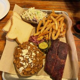 Pork ribs w/ coleslaw, baked beans and French fries.