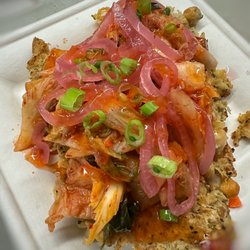 The Hidden Chickpea - Chickpea roasted with Parmesan cheese, pesto topped with kimchi, scallions, pickled onions & sweet chili sauce