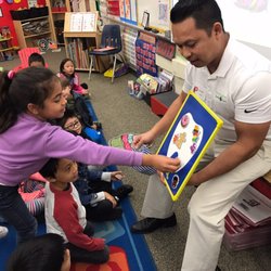 Huntington Smile Care - Dr. Dinh teaching children what is healthy for their teeth.