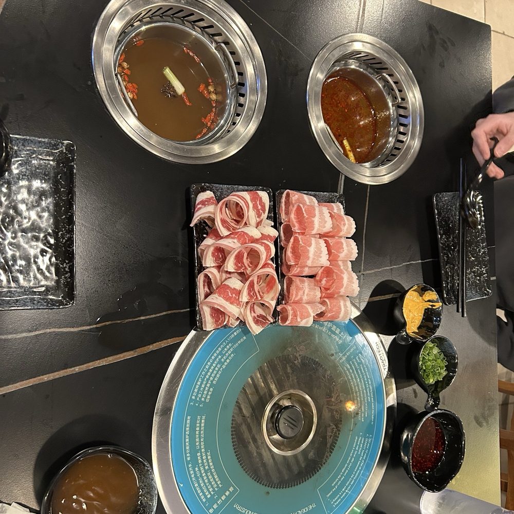 Pork belly and beef belly + hot pot simmering right before the vermicelli, veggies, and additional meats arrived Pork belly and beef belly + hot pot simmering right before the vermicelli, veggies, and additional meats arrived