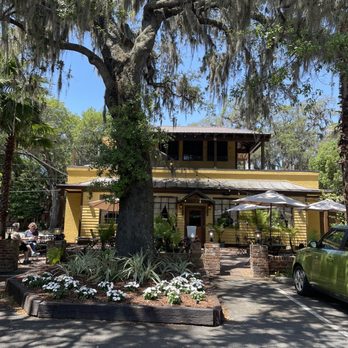 Yellow Deli And Bakery - a green car parked in front of a yellow building - Delis Near Me - Brunswick, Georgia