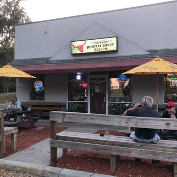 Whiskey River Saloon - two people sitting on a bench - Dive Bars Near Me - Hernando, Florida Whiskey River Saloon - two people sitting on a bench - Dive Bars Near Me - Hernando, Florida